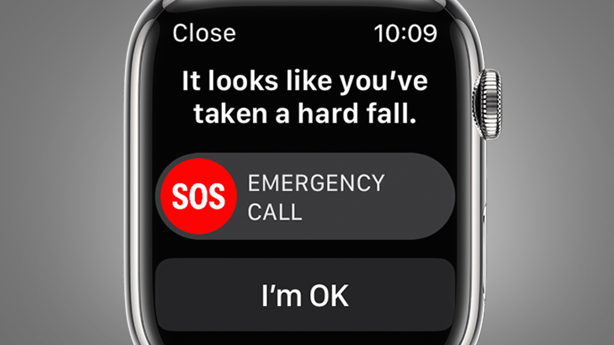 Un Apple Watch sobre un fondo gris que muestra una pantalla de detección de caídas de emergencia