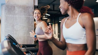 Two women trying some of the best treadmill workouts at the gym 