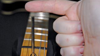 How to adjust an electric guitar's truss rod