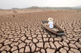 man in a bought on dry cracked ground