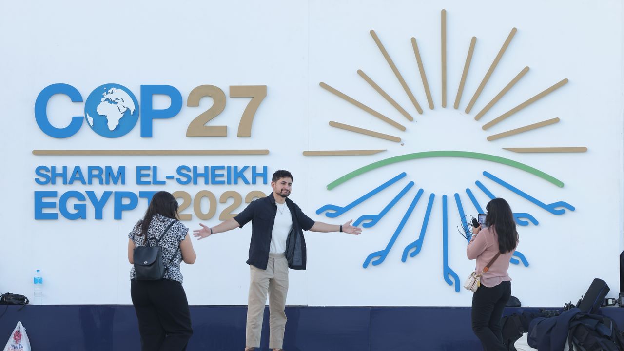 Attendees photograph one another outside the main entrance on the first day of the UN climate conference