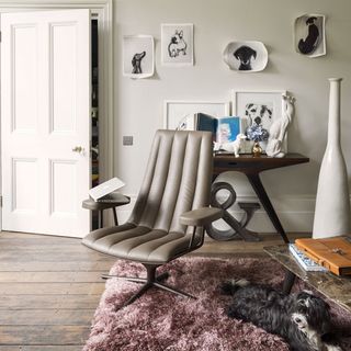 room with white wall and wooden floor and leather chair and white door