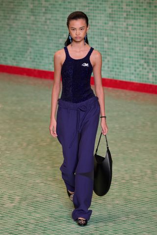 Woman in bodysuit and track pants on the Tory Burch spring 2025 runway