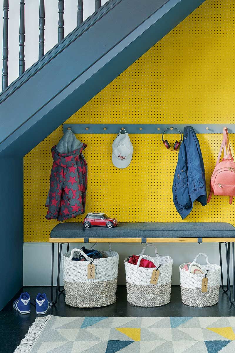 Blue and yellow decorated hallway to show how to organise a small hallway with small children