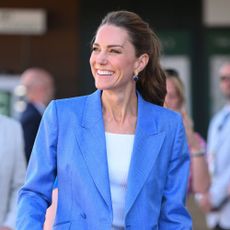Kate Middleton arrives at Wimbledon wearing a powder blue suit with brown heels.