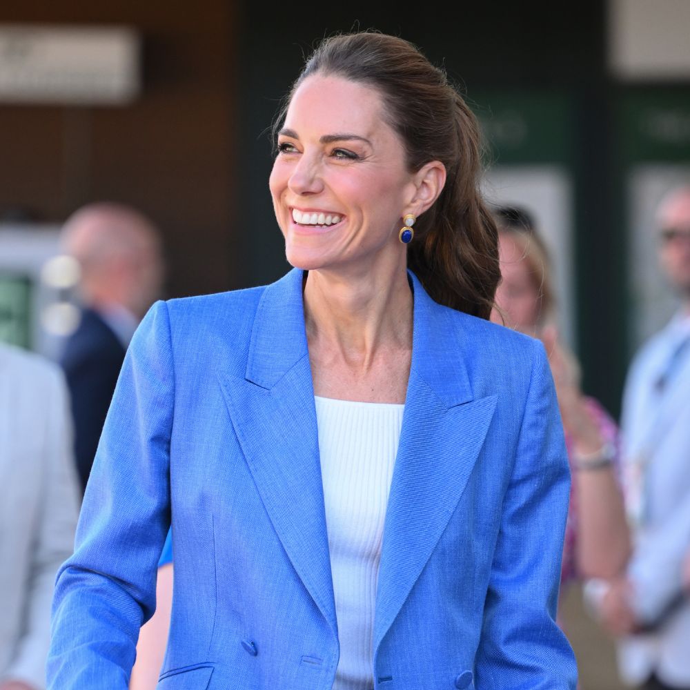 Kate Middleton arrives at Wimbledon wearing a powder blue suit with brown heels.