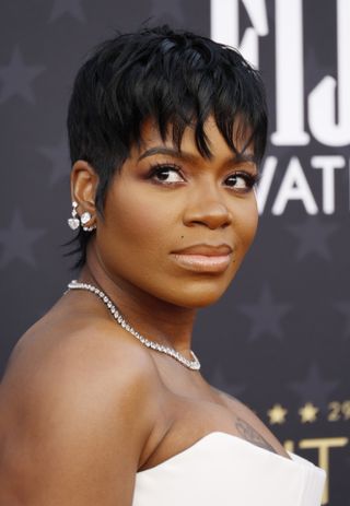 fantasia with short hair styled in a pixie cut.