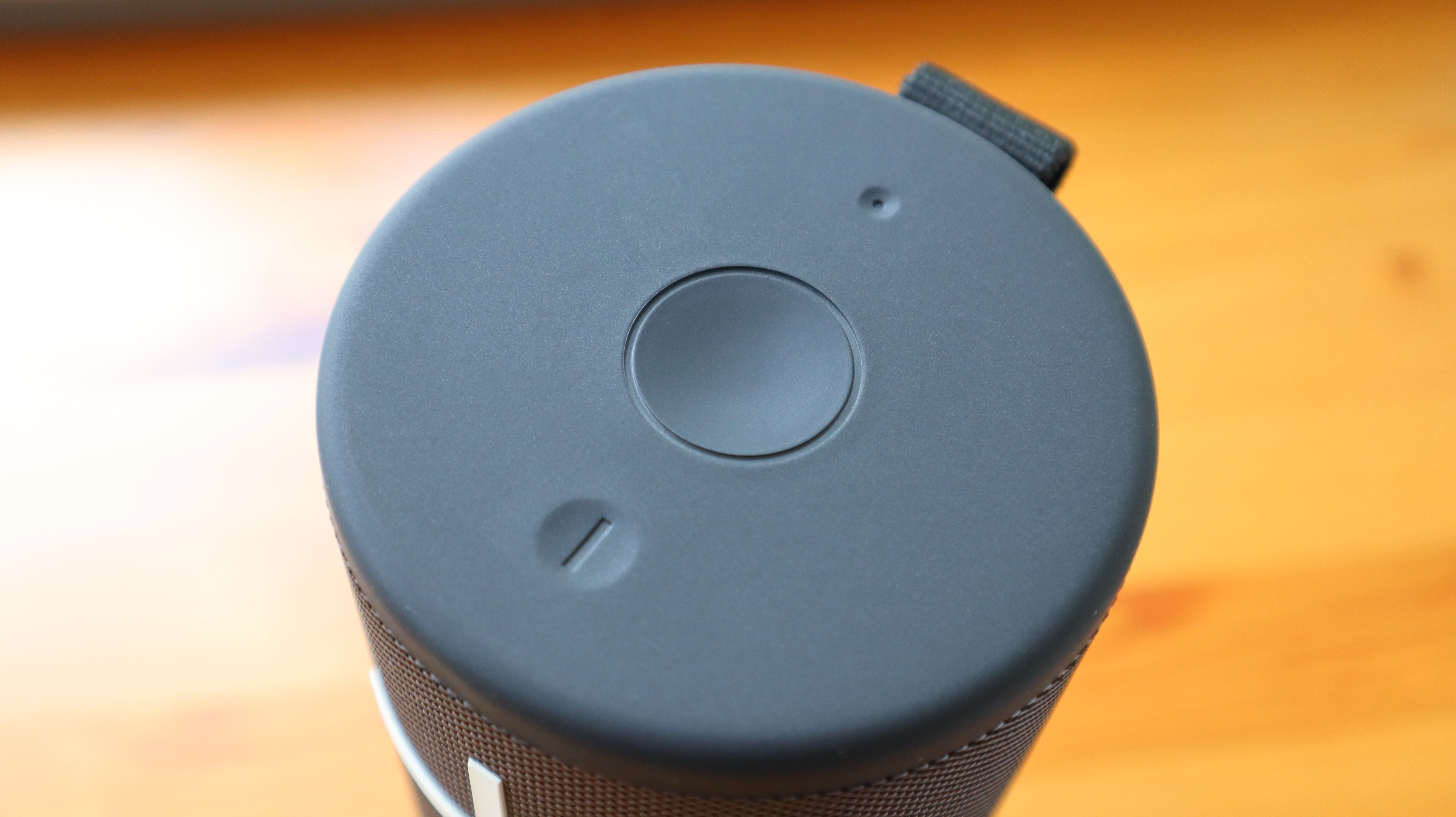 Ultimate Ears Megaboom 4 in black, in a house with white window frames in the background