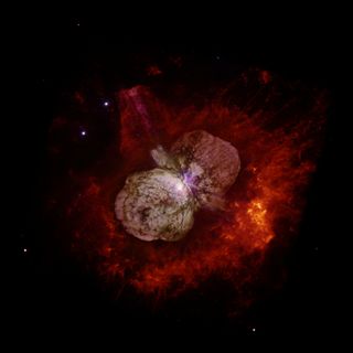 The star system Eta Carinae erupted in the 1840s, from Earth's perspective, creating the Homunculus Nebula visible in this image from the Hubble Space Telescope. New work shows the system spitting ultrafast cosmic rays.