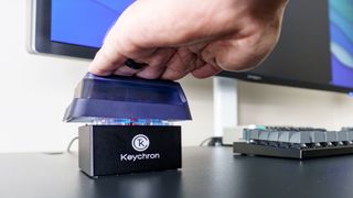 A person using the Keychron Q0 Mini 8K Action Key at their desk