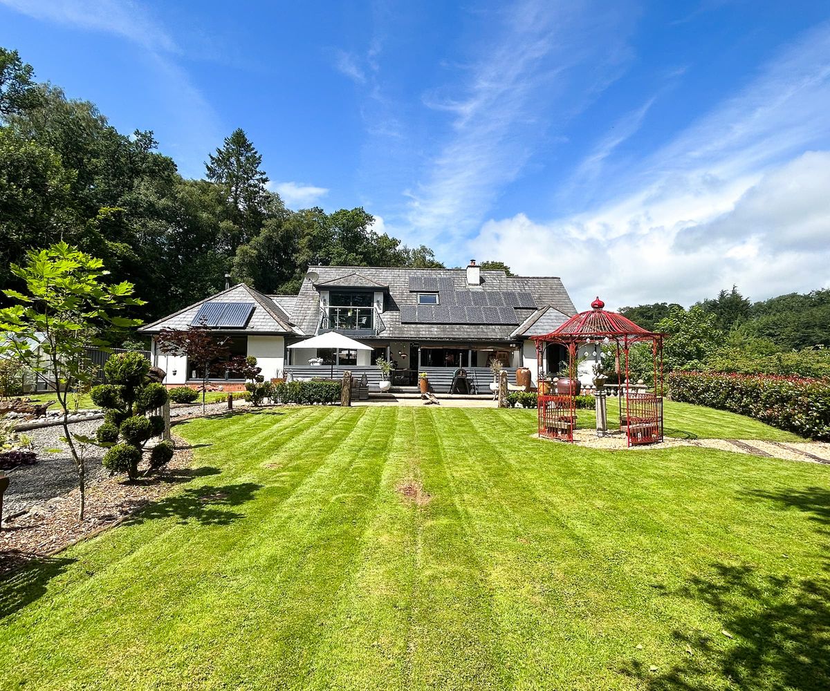 An extended bungalow with solar panels and long garden