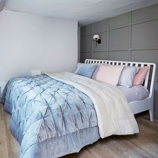 grey panelled bedroom with blue bedlinen