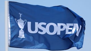 A large US Open blue flag blows in the wind