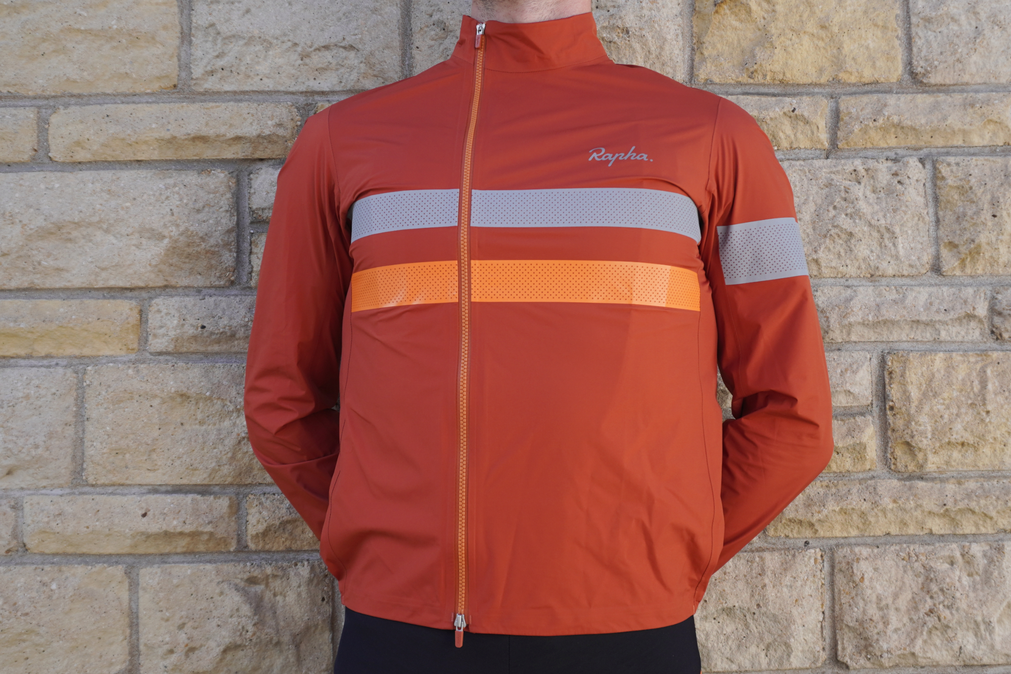 Rapha Brevet Gore-Tex Rain Jacket worn by cyclist standing against a wall