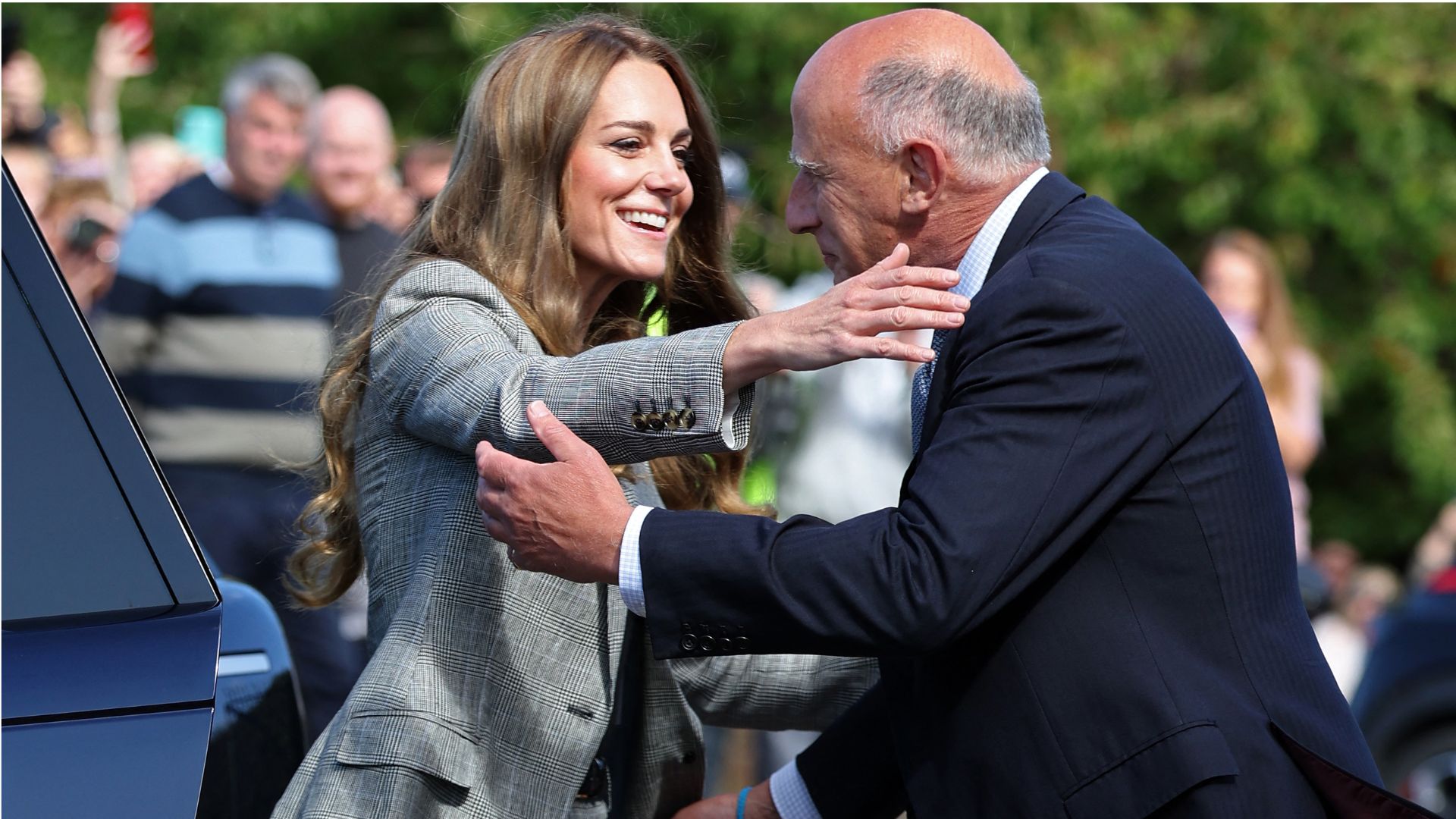 Kate Middleton hugs Jamie Lowther-Pinkerton as she arrives to visit Sudbury Silk Mills in Sudbury, eastern England on September 11, 2025