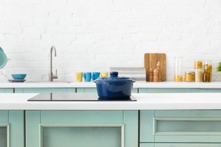 Selective focus of modern white and turquoise kitchen interior