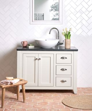 white tiles in bathroom with terracotta octagonal tiles on the floor