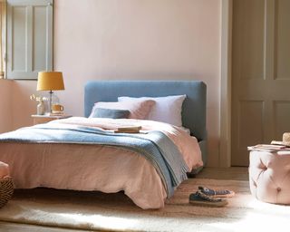 A bedroom with pastel colored decor including Loaf's 'bed in a bun' foldable bed