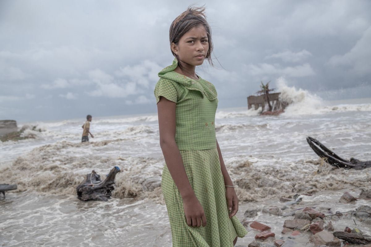 Girl standing in the ruins of her tea shop in the Sundarbans 