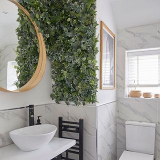 bathroom with white wall and mirror