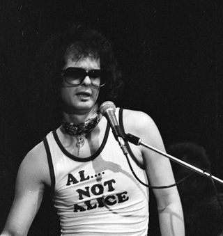 Al Kooper onstage wearing an "Al... not Allice" t-shirt