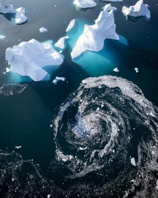 Ice and debris swirling around an iceberg