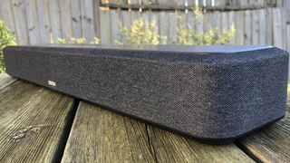 Denon Home Sound Bar 550 on wooden surface