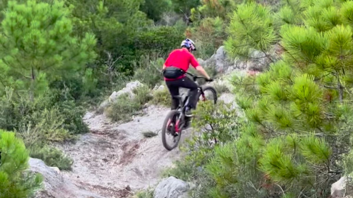 Tom Oehler rides an eMTB up a steep slope