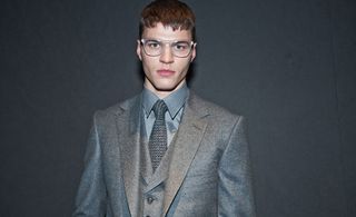 Gieves & Hawkes A/W 2014 - young man in grey suit wearing spectacles