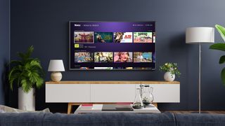 Roku TV on wall with What to watch menu on screen 