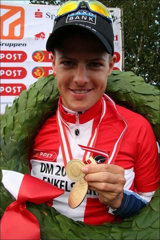 Jakob Fuglsang (Team Saxo Bank) shows off his medal and jersey.