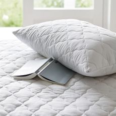 For best cooling mattress toppers, the White company best overall cooling topper on bed wiith matching pillow protector
