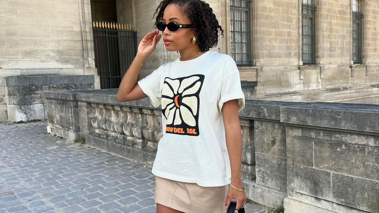 Ellie Delphine graphic t-shirt and beige mini skirt hero