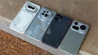 A Nothing Phone 3a Lite, 4a, 4a Pro, and 3a Pro on a concrete step