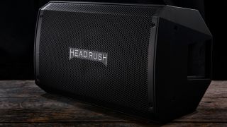 A HeadRush FRFR-112 FRFR speaker on a wooden floor