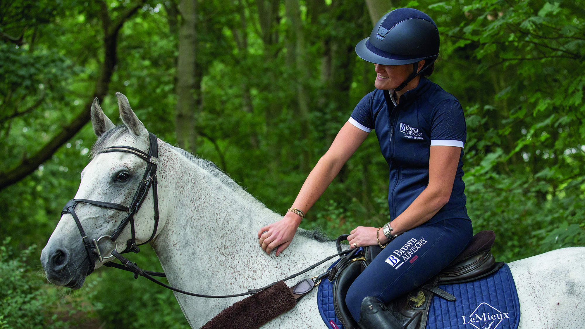 Bubby Upton riding her grey horse Its Cooley Time in a photoshoot at home in 2025.