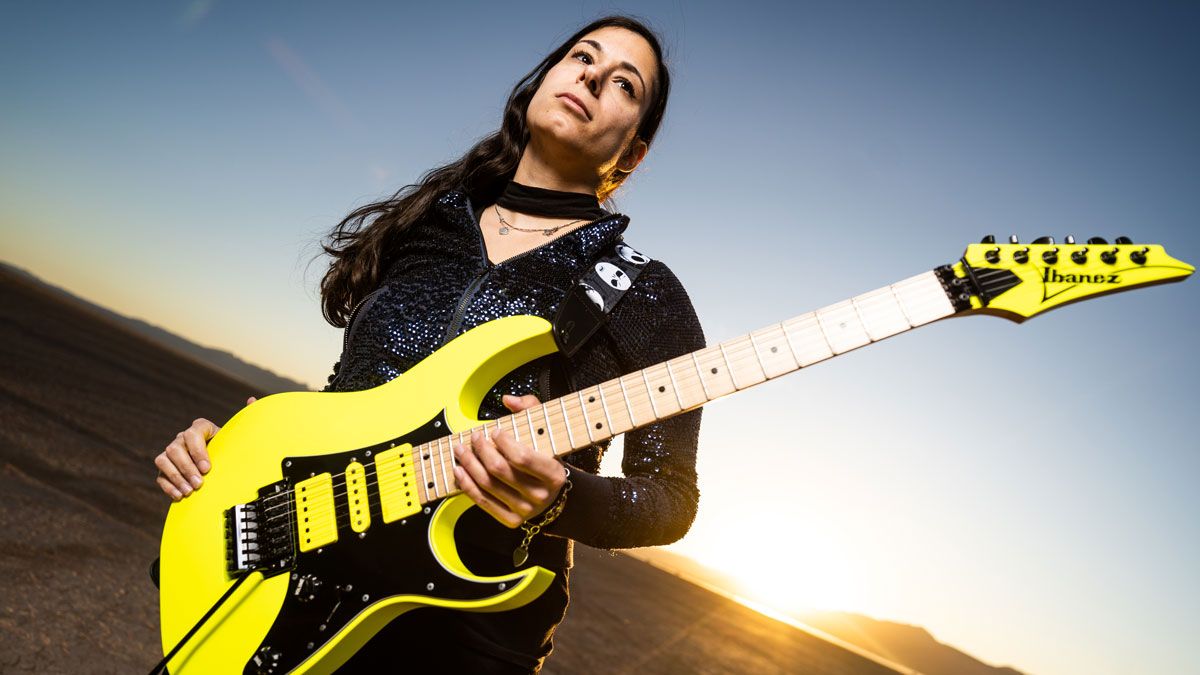 Nili Brosh poses with her custom Ibanez RG electric guitar