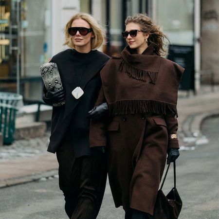 Two woman holding arms at Copenhagen F/W 26 