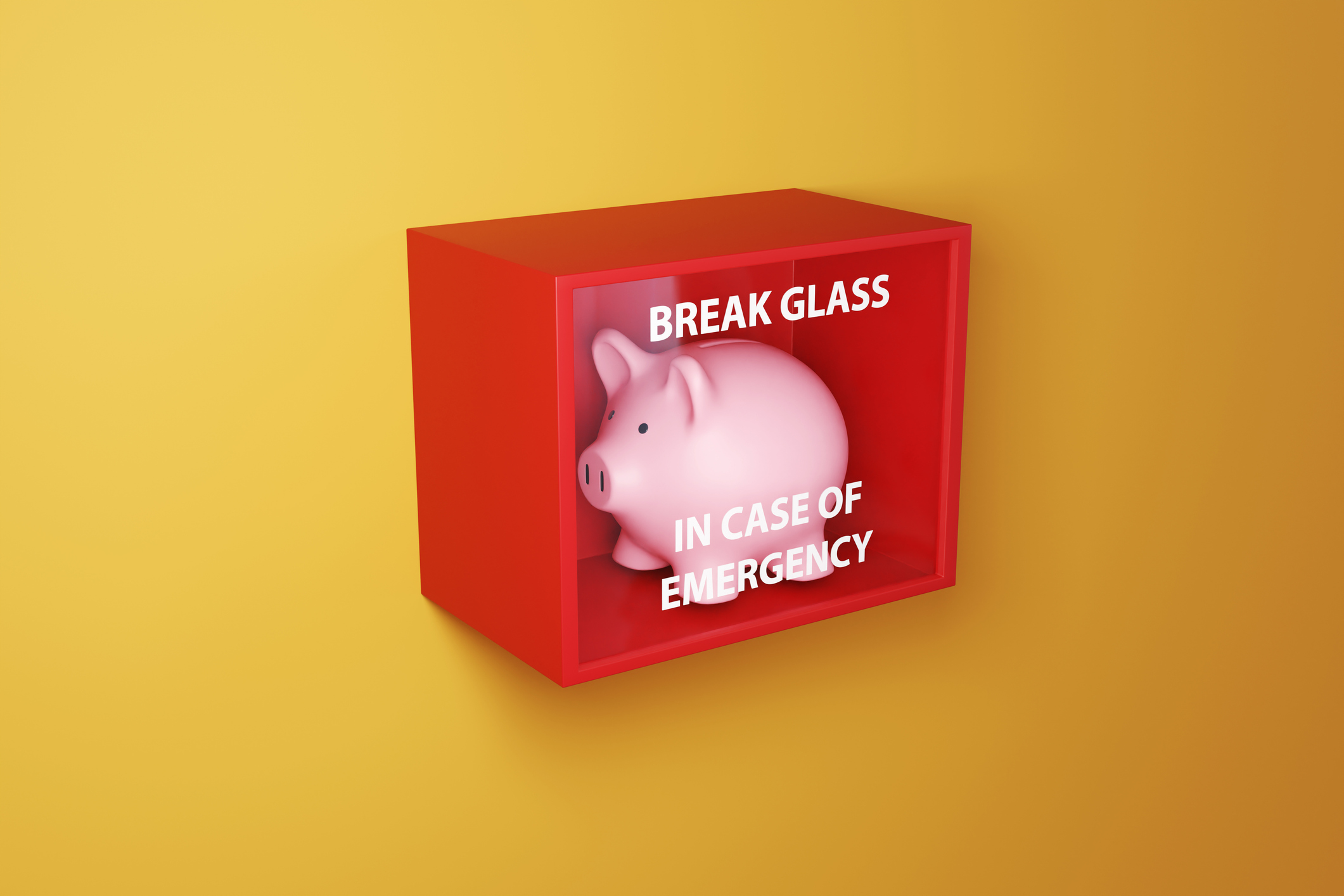Pink piggy bank in a red box with a glass printed with the instruction BREAK GLASS IN CASE OF EMERGENCY on a yellow wall.
