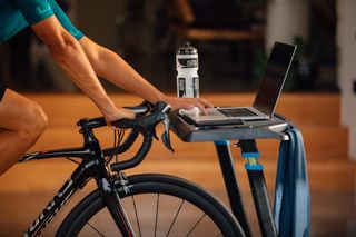 Male cyclist using ERG mode on his smart trainer for his indoor cycling session