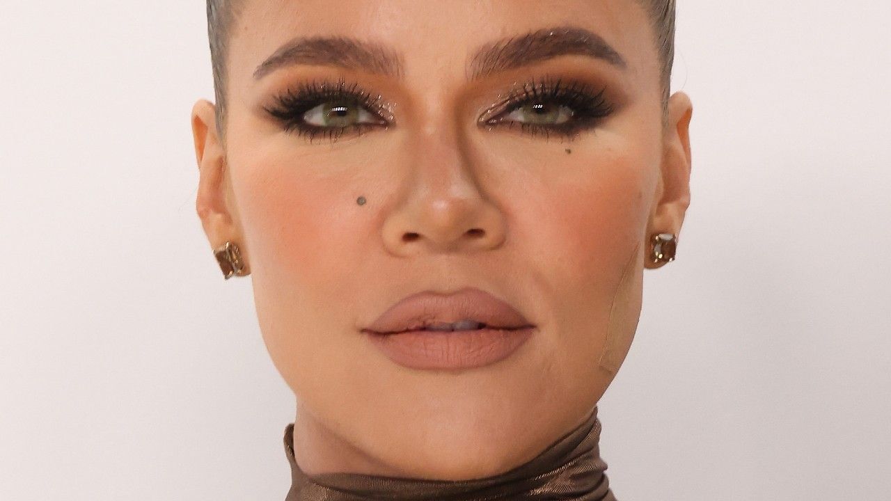 Close up shot of Khloe Kardashian with hair pulled back, heavy eye makeup