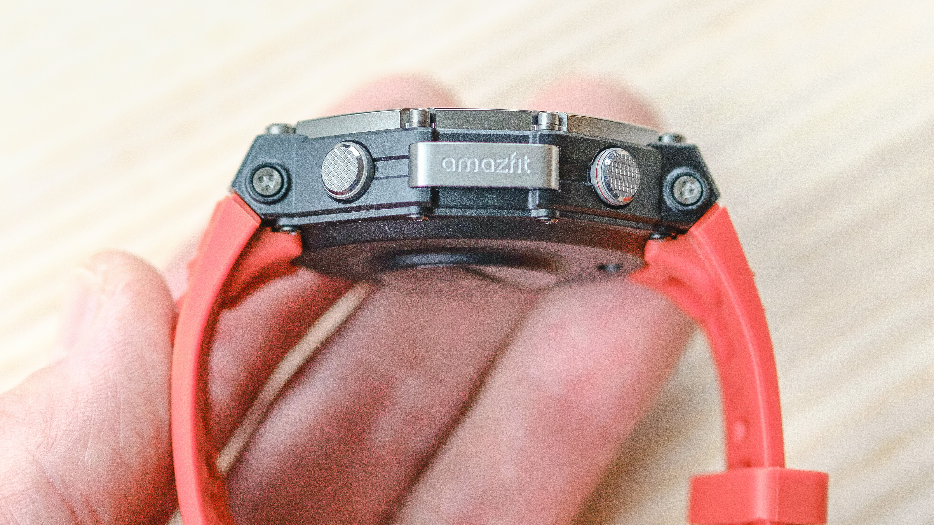 Close up of the Amazfit T-Rex 3 smartwatch on an orange silicone strap