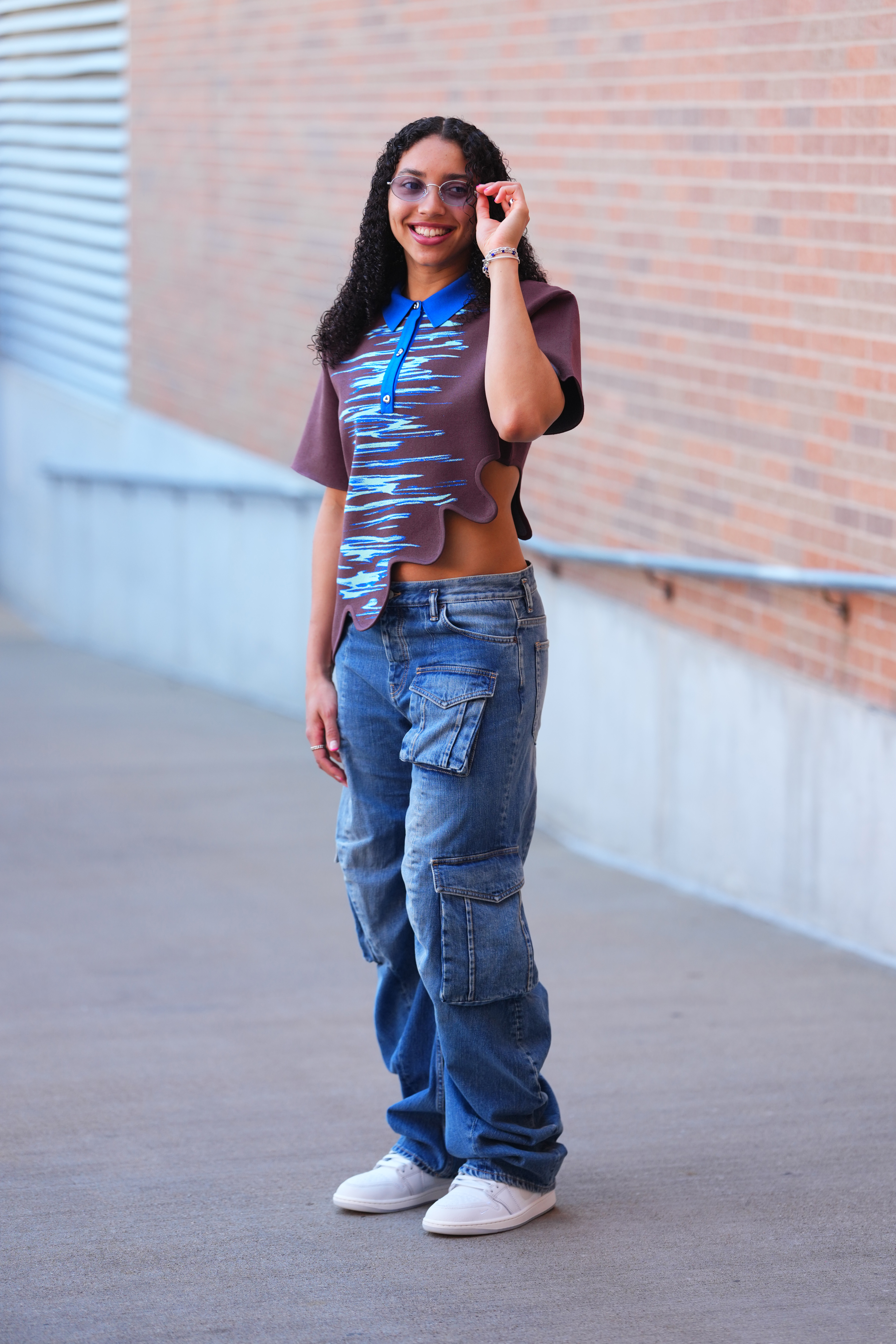 Azzi Fudd's WNBA tunnel style starts with low-rise cargo jeans and a quirky polo shirt
