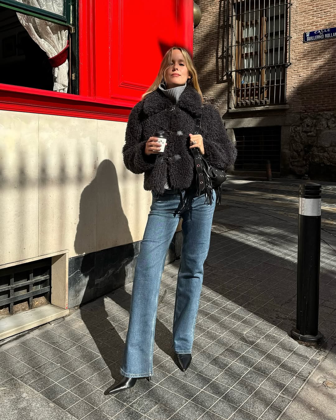 Woman wearing bootcut jeans with stiletto ankle boots.