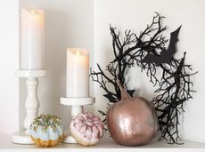 Painted rose gold pumpkins on a white mantel