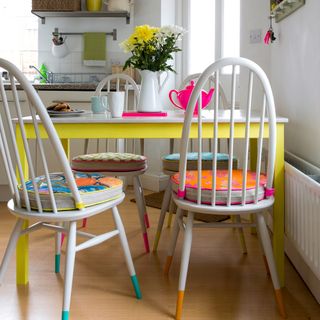 dining room with white dining table and chairs with painted colours