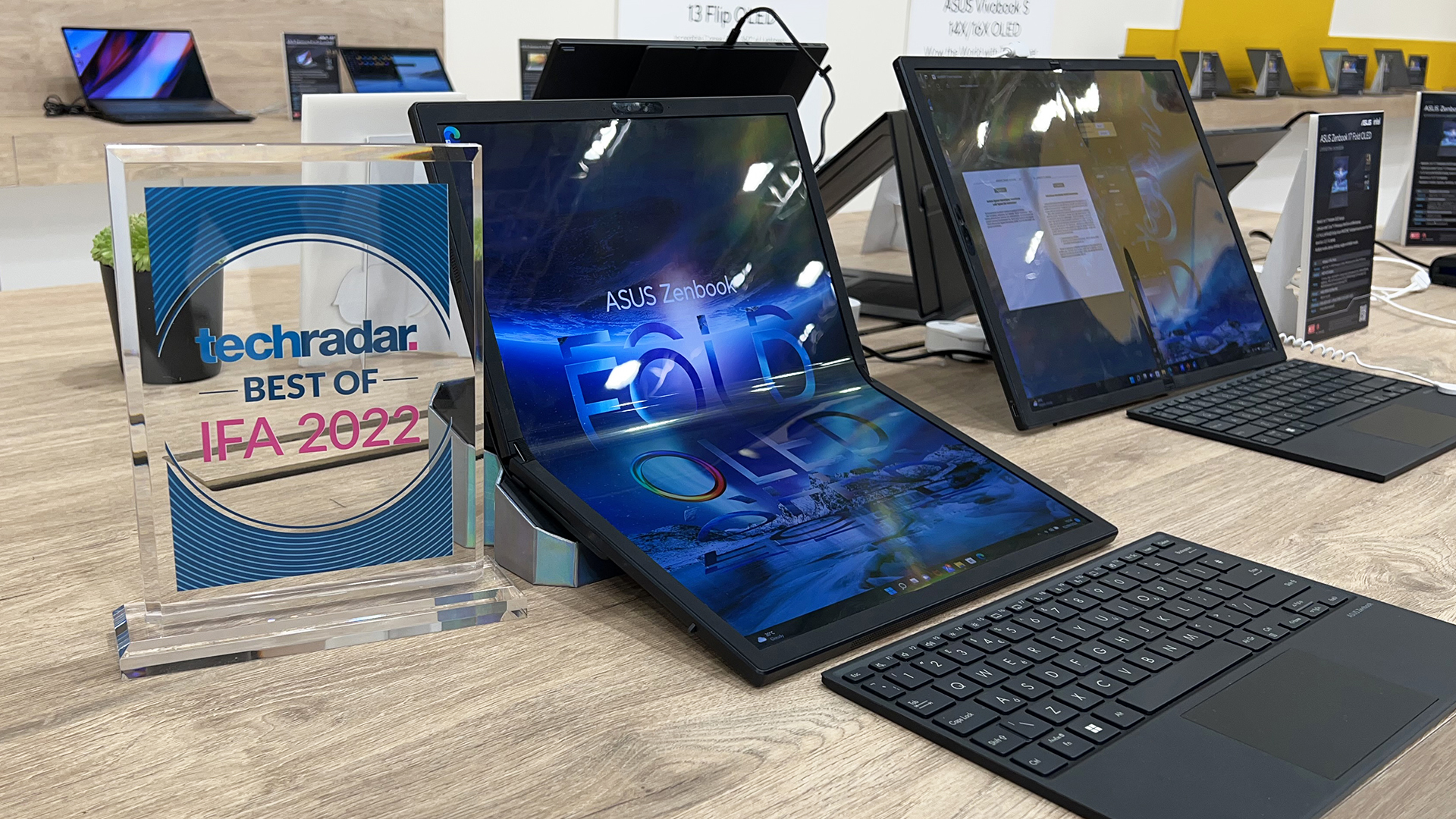 IFA 2022 award with Asus Zenbook 17 Fold OLED laptop and keyboard.
