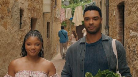 Halle Bailey and Rege Jean Page walking in You, Me, and Tuscany. 