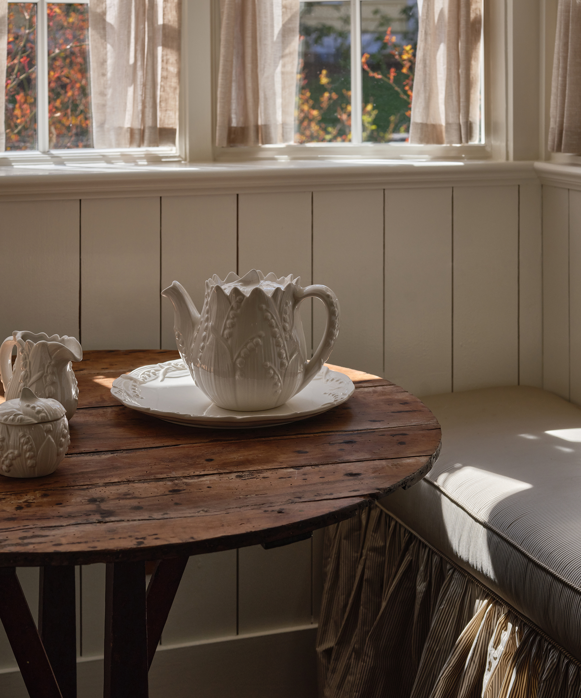 rustic dining table with vintage tea set on it