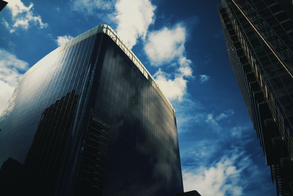 Photograph taken with the RewindPix digital compact showing tall building against dramatic sky with stylised cool tones